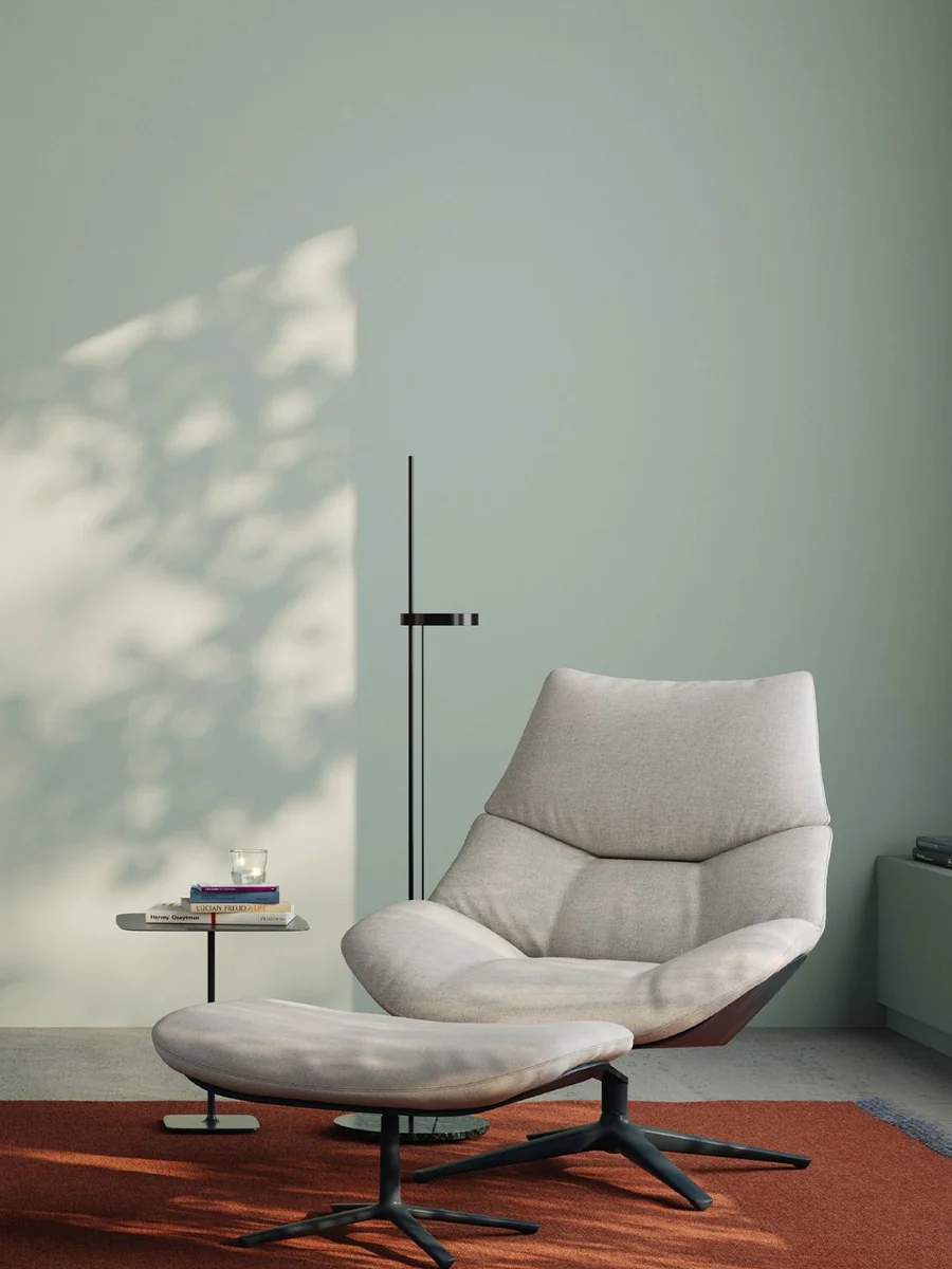 CGI lifestyle render of a lounge chair and ottoman on a rust rug