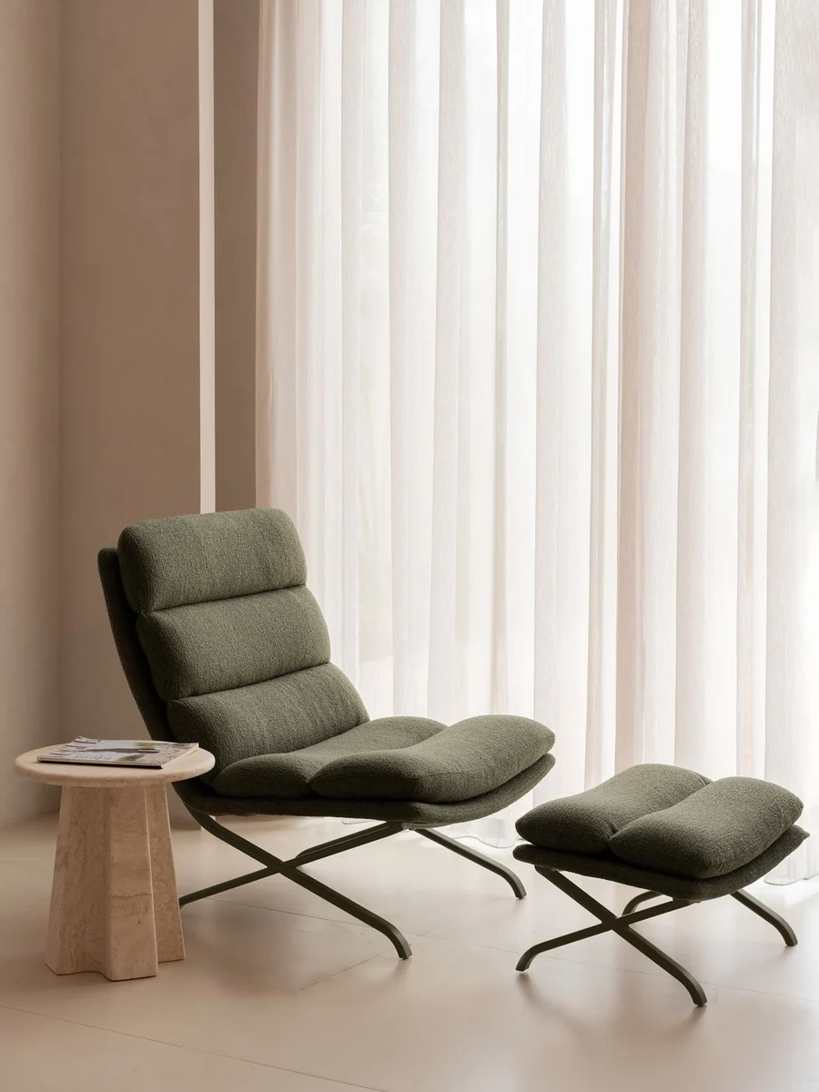 CGI lifestyle render of an olive lounge chair and ottoman by a curtained window