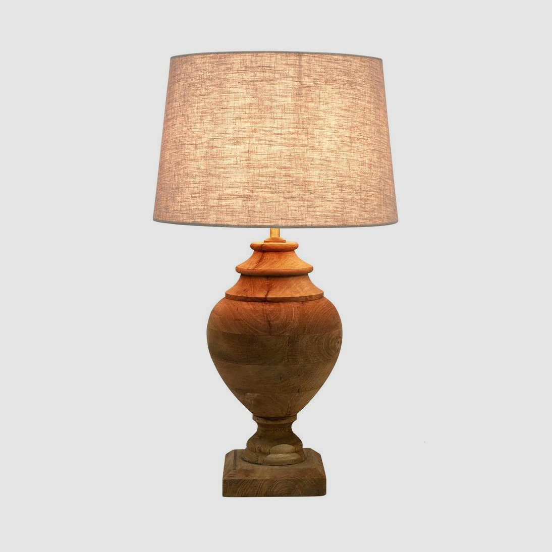 Amphora table lamp with a turned dark natural timber base and linen shade, the product photo supplied by the brand