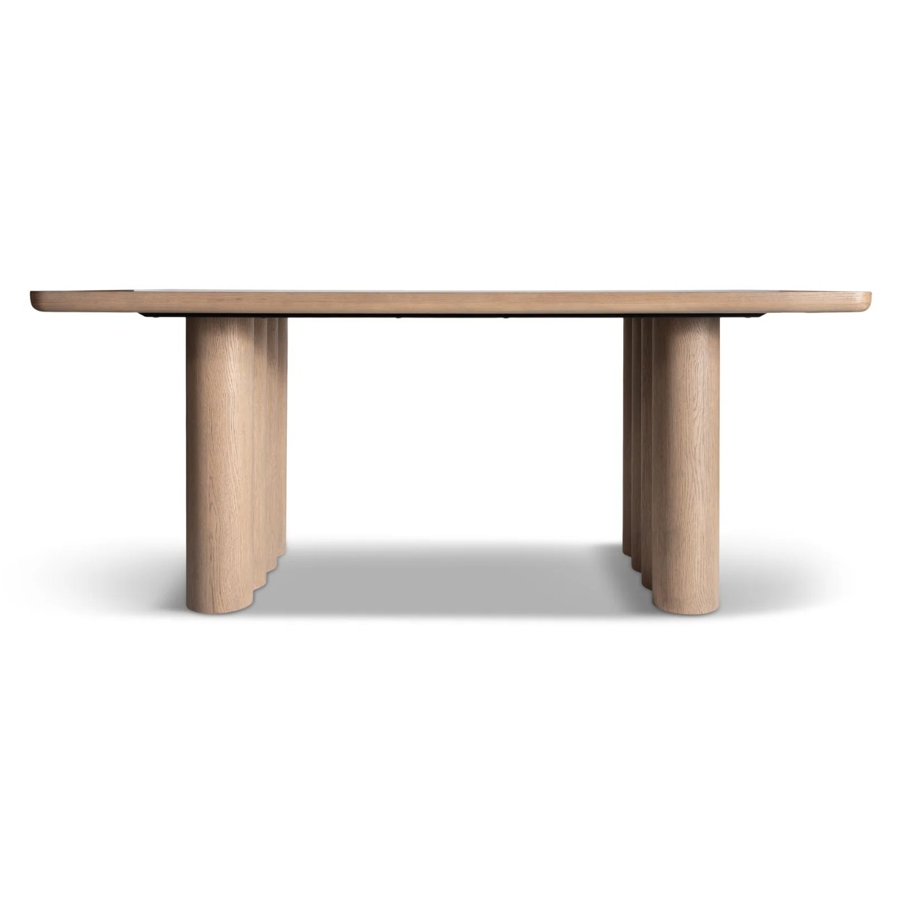 Oak dining table on fluted legs, the product photo supplied by the brand