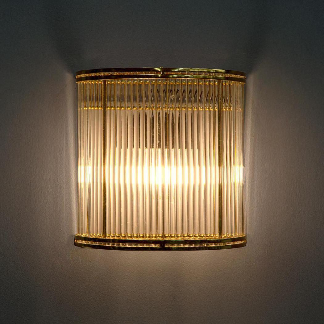 Verre half round wall light in brass and ribbed glass, lit, the product photo supplied by the brand